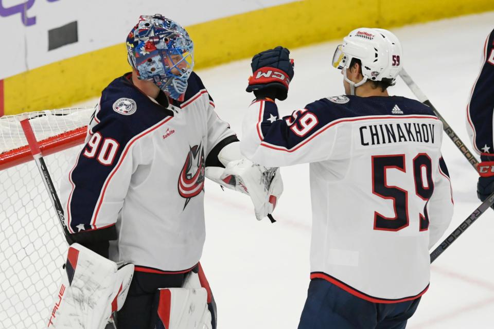 Columbus Blue Jackets goalie Elvis Merzlikins (90) celebrates with teammate Yegor Chinakhov (59) after defeating the Chicago Blackhawks in an NHL hockey game Saturday, March 2, 2024, in Chicago. (AP Photo/Paul Beaty)