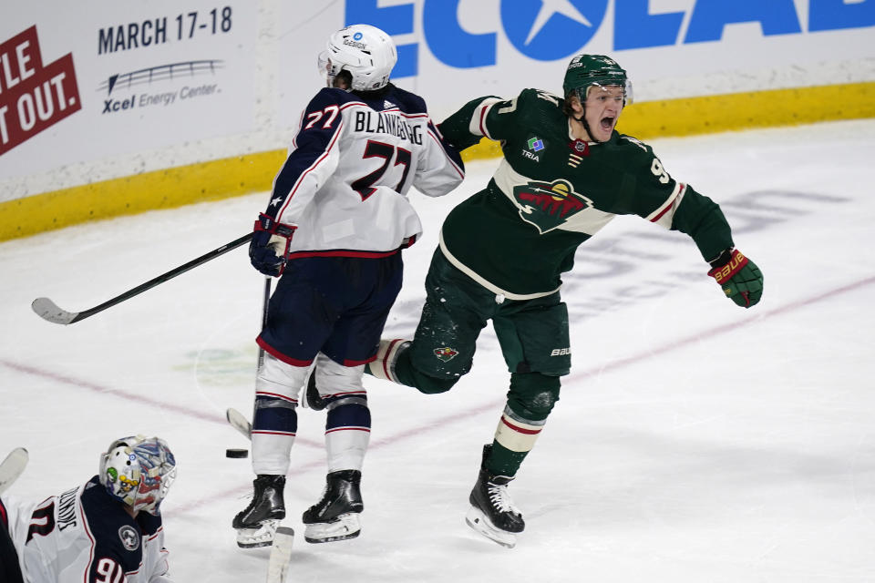 Minnesota Wild left wing Kirill Kaprizov, right, celebrates after scoring the game-winning goal to defeat the Columbus Blue Jackets during overtime of an NHL hockey game Sunday, Feb. 26, 2023, in St. Paul, Minn. (AP Photo/Abbie Parr)