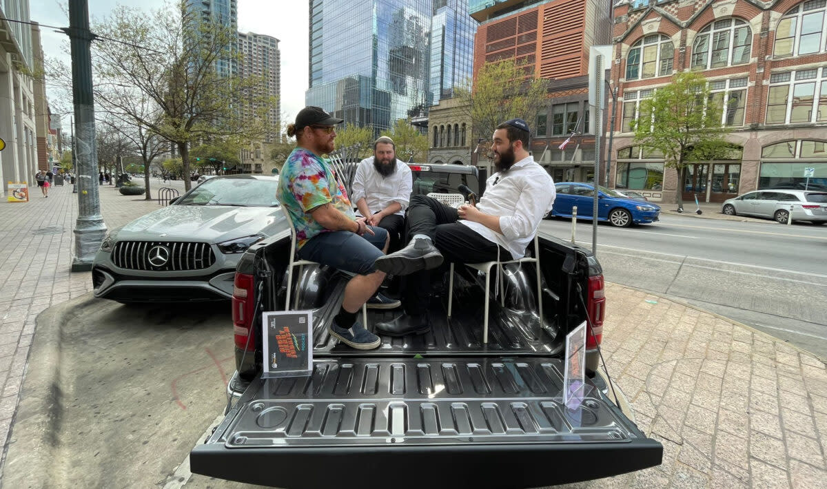 Members of Chabads Tech Tribe speak with a South by Southwest Festival attendee in their Podcast Pickup Truck in Austin, Texas, in March 2024.