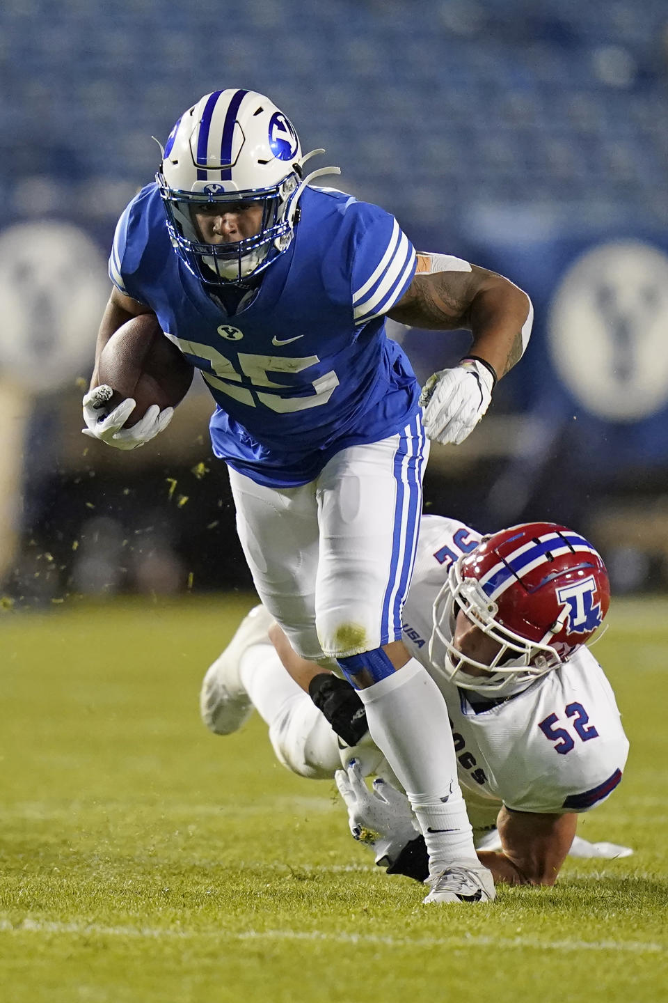 Louisiana Tech linebacker Tyler Grubbs (52) reaches for BYU running back Tyler Allgeier (25) during the first half during an NCAA college football game Friday, Oct. 2, 2020, in Provo, Utah. (AP Photo/Rick Bowmer, Pool)