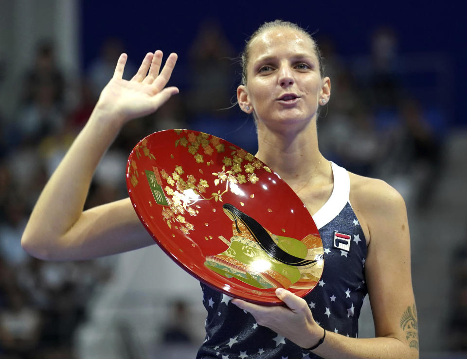 CORRECTS FIRST NAME OF OSAKA - Karolina Pliskova of Czech Republic celebrates with her champion trophy during the award ceremony of the Pan Pacific Open women's tennis tournament in Tokyo Sunday, Sept. 23, 2018. Pliskova won over Naomi Osaka of Japan in the final. (AP Photo/Eugene Hoshiko)