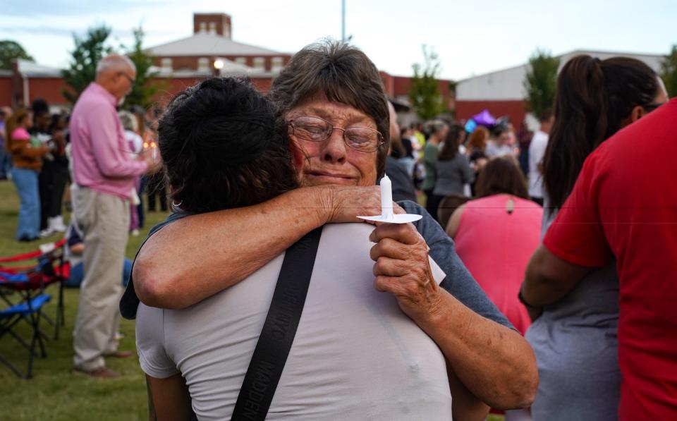 Friends embrace as they cried for the dead and injured