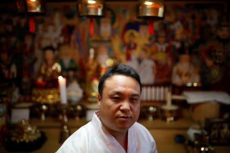 Jang Yong-jun, a traditional shaman, poses for photographs at his home in Seoul, South Korea, September 13, 2017. Picture taken on September 13, 2017. REUTERS/Kim Hong-Ji