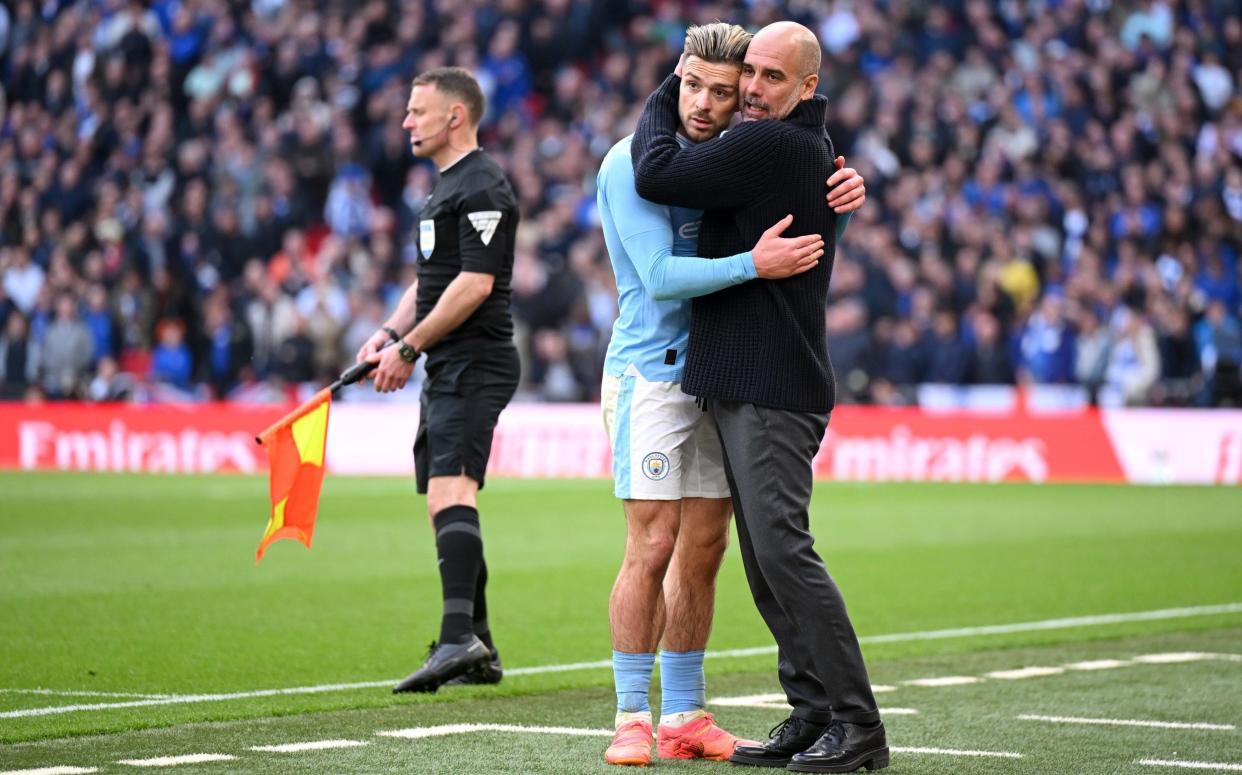 Everything feels better after a hug...Grealish is consoled by Guardiola