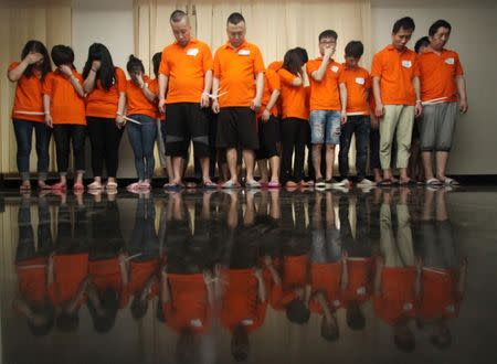 Chinese nationals suspected of involvement in cyber crime are pictured in Jakarta police headquarters, Indonesia, July 31, 2017 in this photo taken by Antara Foto. Antara Foto/Reno Esnir via REUTERS. ATTENTION EDITORS - THIS IMAGE WAS PROVIDED BY A THIRD PARTY. MANDATORY CREDIT. INDONESIA OUT. NO COMMERCIAL OR EDITORIAL SALES IN INDONESIA.