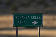 A sign stands near the Bonanza Creek Film Ranch in Santa Fe, N.M., Saturday, Oct. 23, 2021. An assistant director unwittingly handed actor Alec Baldwin a loaded weapon and told him it was safe to use in the moments before the actor fatally shot a cinematographer, court records released Friday show. (AP Photo/Jae C. Hong)
