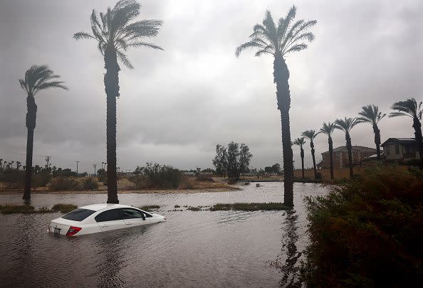 CATHEDRAL CITY, CALIFORNIA - AUGUST 20: A car is partially submerged in floodwaters as Tropical Storm Hilary moves through the area on August 20, 2023 in Cathedral City, California. Southern California is under a first-ever tropical storm warning as Hilary impacts parts of California, Arizona and Nevada. All California state beaches have been closed in San Diego and Orange counties in preparation for the impacts from the storm which was downgraded from hurricane status. (Photo by Mario Tama/Getty Images)