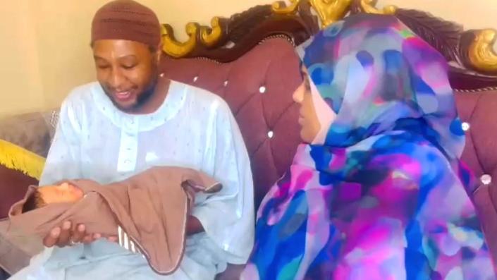 Bashayar al-Fadil sitting next to her husband as he holds their baby