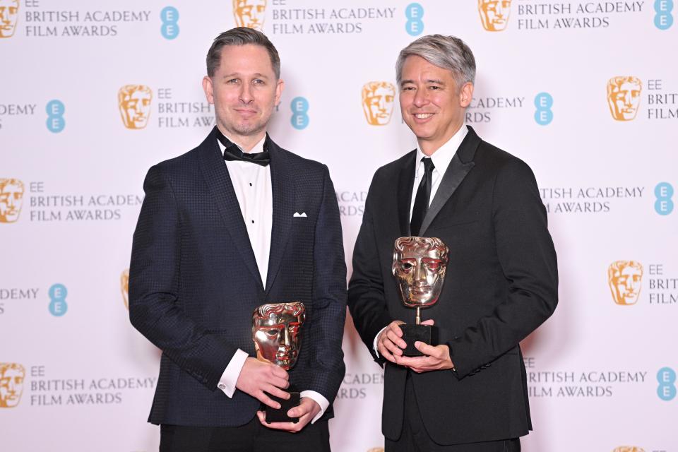 LONDON, ENGLAND - MARCH 13:  Elliot Graham and Tom Cross with the Best Editing award for 'No Time To Die' pose in the winners room during the EE British Academy Film Awards 2022 at Royal Albert Hall on March 13, 2022 in London, England. (Photo by Samir Hussein/WireImage)
