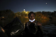 The migrant mother of a child that was rescued by United States agents from the waters of the Rio Grande after she lost her footing and the child began to be swept away by the current, cries after she too was helped ashore on the American side of the border between Ciudad Acuña, Mexico, and Del Rio, Texas Thursday, Sept. 23, 2021. (AP Photo/Felix Marquez)