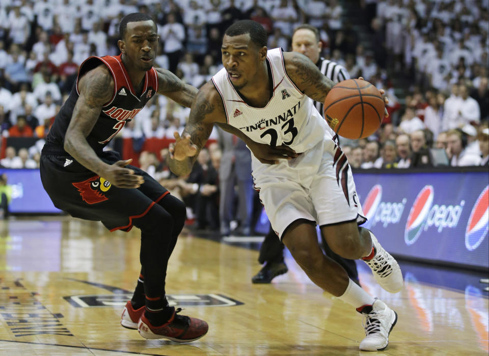 FILE - In this Feb. 22, 2014 file photo, Cincinnati guard Sean Kilpatrick (23) drives past Louisville guard Russ Smith (2) in the first half of an NCAA college basketball game in Cincinnati. Kilpatrick was selected to The Associated Press All-America team, released Monday, March 31, 2014. (AP Photo/Al Behrman. File)