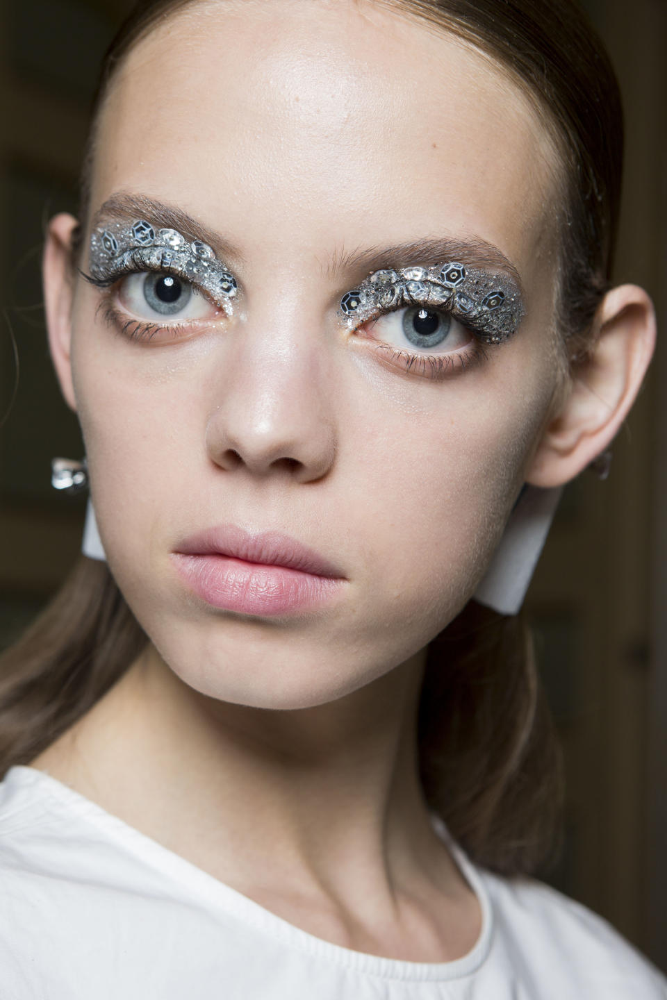 <p>Sci-fi chic silver sequin eye make-up is the ideal way to jazz up a Christmas party LBD.</p>
