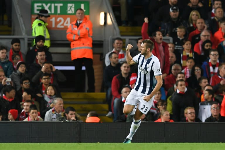 West Bromwich Albion's defender Gareth McAuley celerbates scoring their first goal during the English Premier League football match between Liverpool and West Bromwich Albion at Anfield in Liverpool, north west England on October 10, 2016