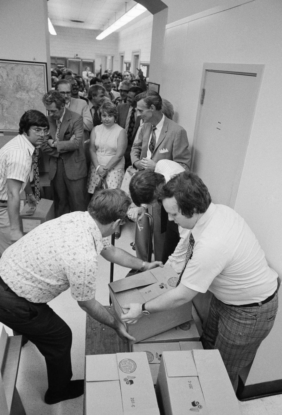 <p>Reporters line up to receive copies of the eight volumes of evidence distributed to the press by the House Judiciary Committee, July 10, 1974, on Capitol Hill. (Photo: Henry Burroughs/AP) </p>