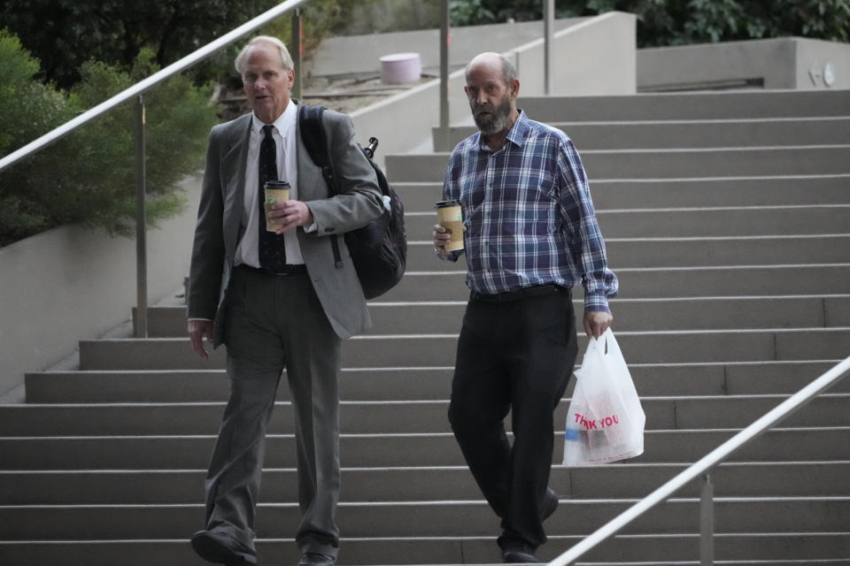 Defendant, Conception's captain Jerry Boylan, right, arrives in federal court in Los Angeles Wednesday, Oct. 25, 2023. Federal prosecutors are seeking justice for 34 people killed in a fire aboard a scuba dive boat called the Conception in 2019. The trial against Boylan began Tuesday with jury selection. Boylan has pleaded not guilty to one count of misconduct or neglect of ship officer. (AP Photo/Damian Dovarganes)