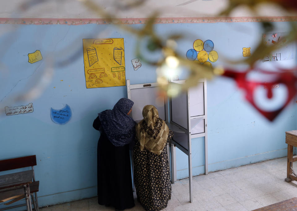 Voters prepare to cast their ballots on constitutional amendments during the second day of three-day voting at polling station in Cairo, Egypt, Sunday, April 21, 2019. Egyptians are voting on constitutional amendments that would allow President Abdel-Fattah el-Sissi to stay in power until 2030. (AP Photo/Amr Nabil)