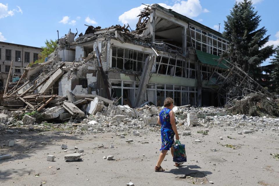 <div class="inline-image__caption"><p>A resident passes by a destroyed building in Lysychansk, Lugansk region, on July 4.</p></div> <div class="inline-image__credit">Victor/Xinhua via Getty</div>