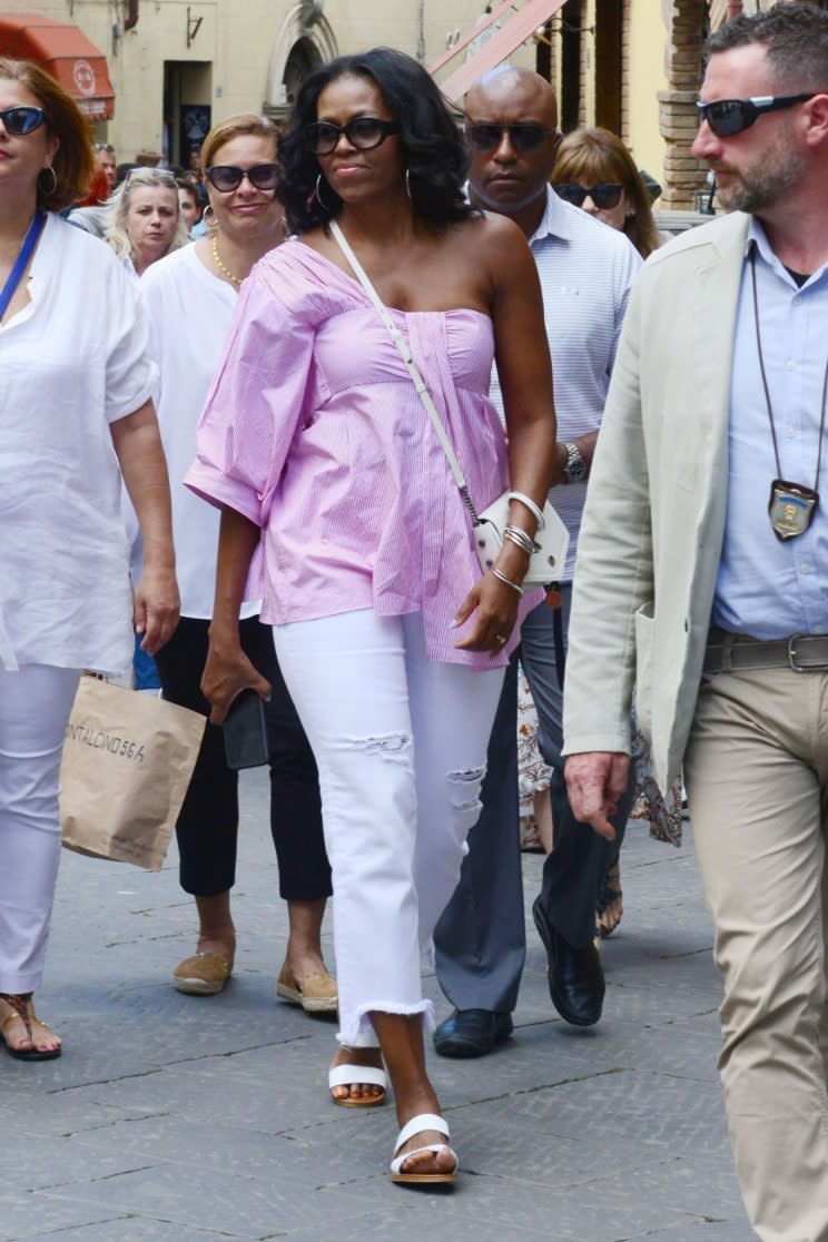 Michelle Obama wearing a pink TEIJA shirt with AG jeans while in Italy. (Photo: AKM-GSI)