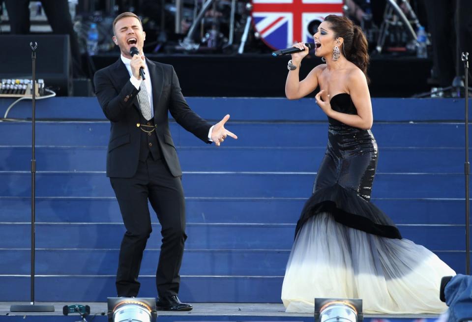 Singers Gary Barlow and Cheryl Cole perform on stage during the Queen’s Diamond Jubilee concert at Buckingham Palace on 4 June 2012 (Getty)