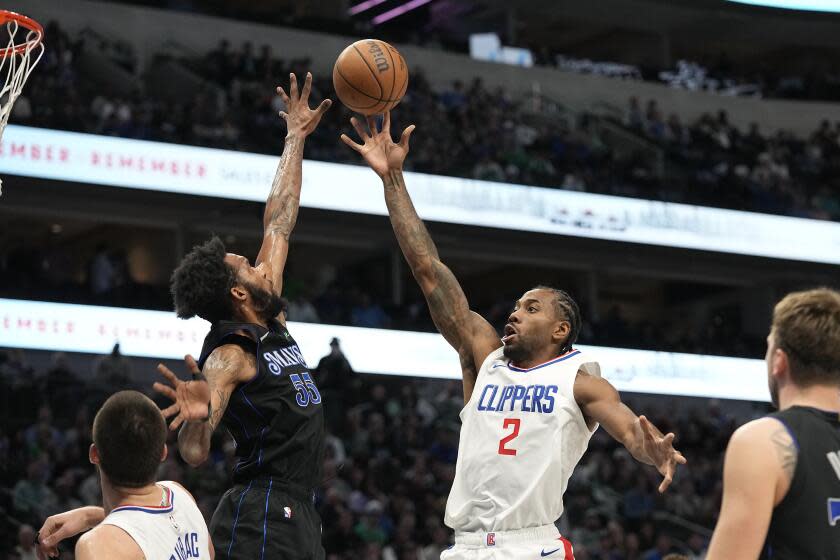 Los Angeles Clippers forward Kawhi Leonard (2) shoots over Dallas Mavericks forward Derrick Jones Jr. (55) during the first half of an NBA basketball game in Dallas, Wednesday, Dec. 20, 2023. (AP Photo/LM Otero)