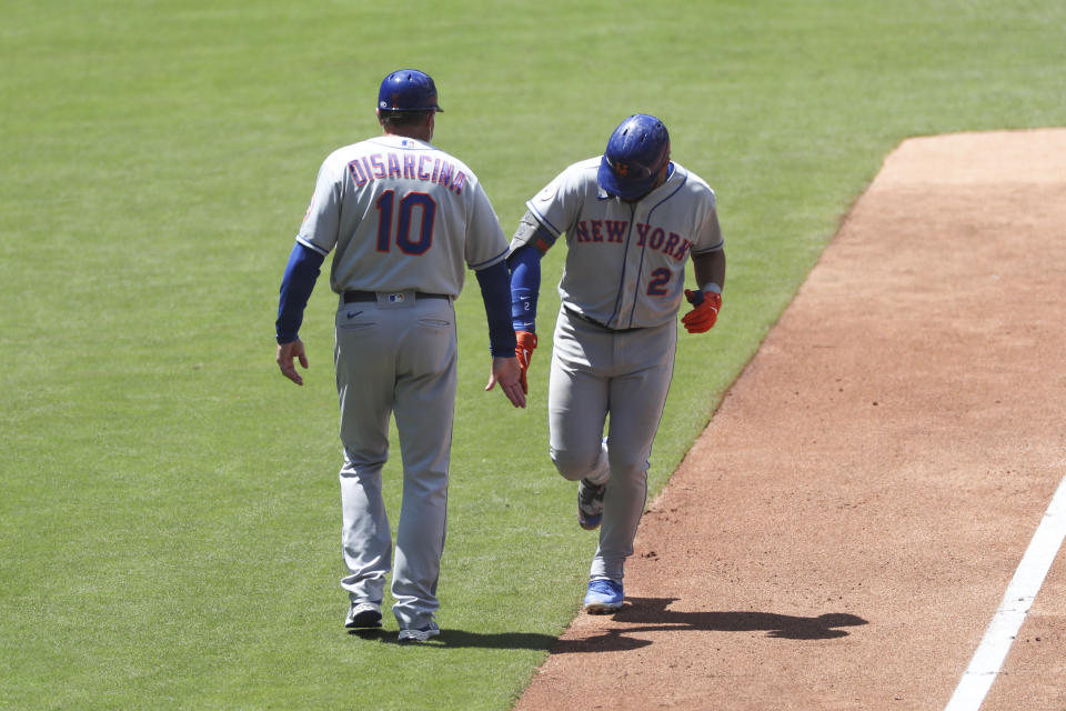 New York Mets' Dominic Smith (2) is congratulated by third base coach Gary Disarcina (10) as he rounds the base after hitting a solo home run off San Diego Padres starting pitcher Chris Paddack in the fourth inning of a baseball game Sunday, June 6, 2021, in San Diego. (AP Photo/Derrick Tuskan)