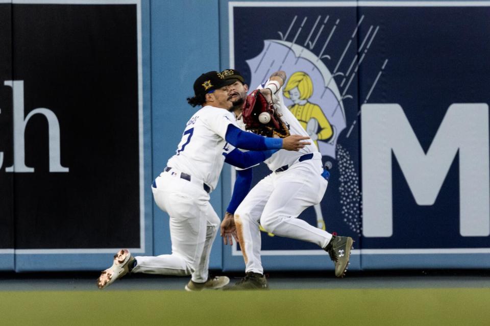 Dodgers left fielder Miguel Vargas collides with center fielder Andy Pages, forcing Pages to drop the ball