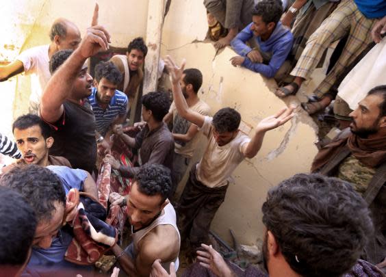 Yemenis carry a body recovered in the rubble of a destroyed building following reported Saudi-led coalition airstrikes in the Yemeni capital Sanaa on May 16 (Mohammed Huwais/AFP/Getty)