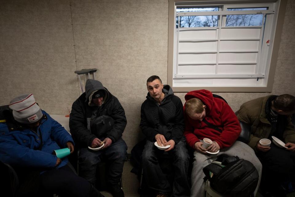 People gather at a daytime warming centre inside a trailer in White Rock, B.C. on January 15, 2024.