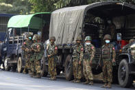 Soldiers stand next to a military truck parked near the headquarters of the National League for Democracy party in Yangon, Myanmar Monday, Feb. 15, 2021. Security forces in Myanmar intensified their crackdown against anti-coup protesters on Monday, seeking to quell the large-scale demonstrations calling for the military junta that seized power earlier this month to reinstate the elected government. (AP Photo)