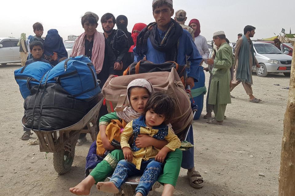 Stranded Afghans return to Afghanistan at the Pakistan-Afghanistan border crossing point in Chaman on Aug. 16, 2021.