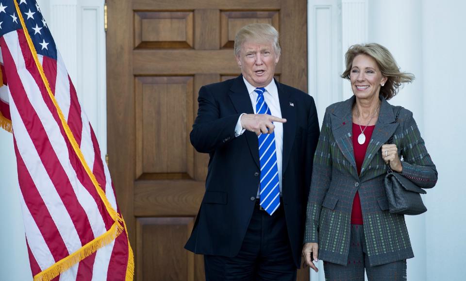 President-elect Donald Trump and Betsy DeVos pose for a photo after their meeting at Trump International Golf Club, November 19, 2016 in Bedminster Township, New Jersey. (Photo: Drew Angerer/Getty Images)