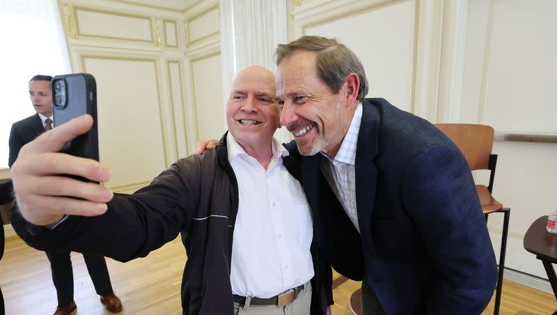 Rep. John Curtis, R-Utah, right, has a selfie taken with Richard Morris after a Utah Aerospace and Defense Association meeting at the Kem C. Gardner Institute in Salt Lake City on Friday, June 2, 2023.
