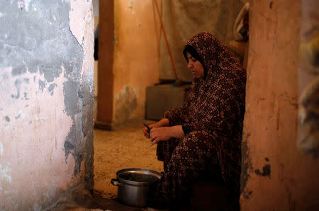 A Palestinian woman prepares food for cooking in her house at Shati refugee camp in Gaza City March 14, 2018. REUTERS/Mohammed Salem