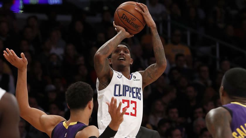 LOS ANGELES, CALIF. - DEC. 28, 2018. Clippers guard Lou Williams shoots over Lakers guard Josh Hart, left, and Kentavious Caldwell-Pope in the fourth quarter Friday night, Dec. 28, 2018, at Staples Center. (Luis Sinco/Los Angeles Times)