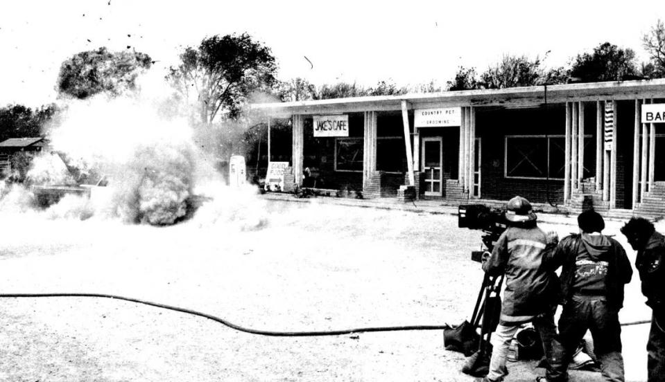Parts fly as a police car explodes for the camera during the filming of “Night Screams.”