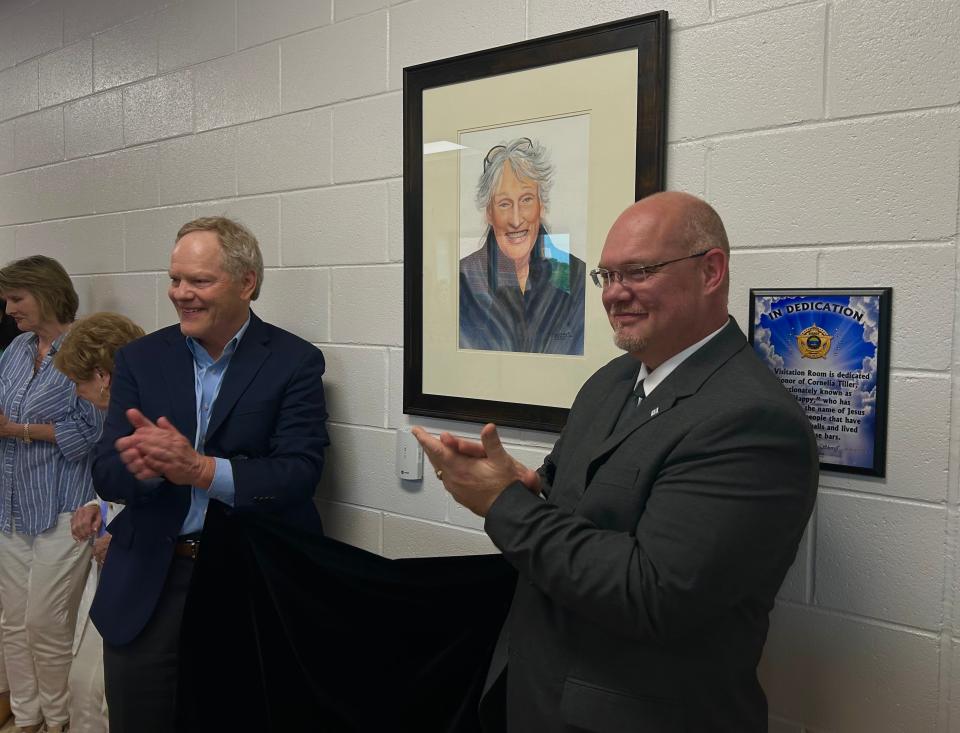 Circuit Court Judge Donald Allen and Madison Co. Sheriff's Office Director of Operations Jeff Wall turn to Cornelia Tiller (Ms. Happy) after the unveiling of her portrait that now hangs in the Madison Co. Jail Visitation Center. Tiller was honored for her 30 years of volunteer service at the jail in Jackson, Tenn., on May 16, 2023.
