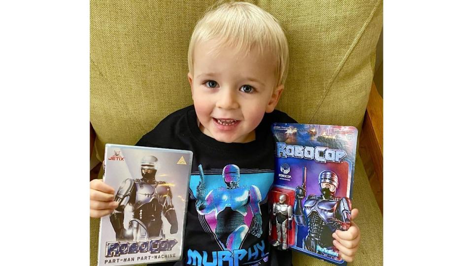 A young blonde chidl with Robocop merchandise