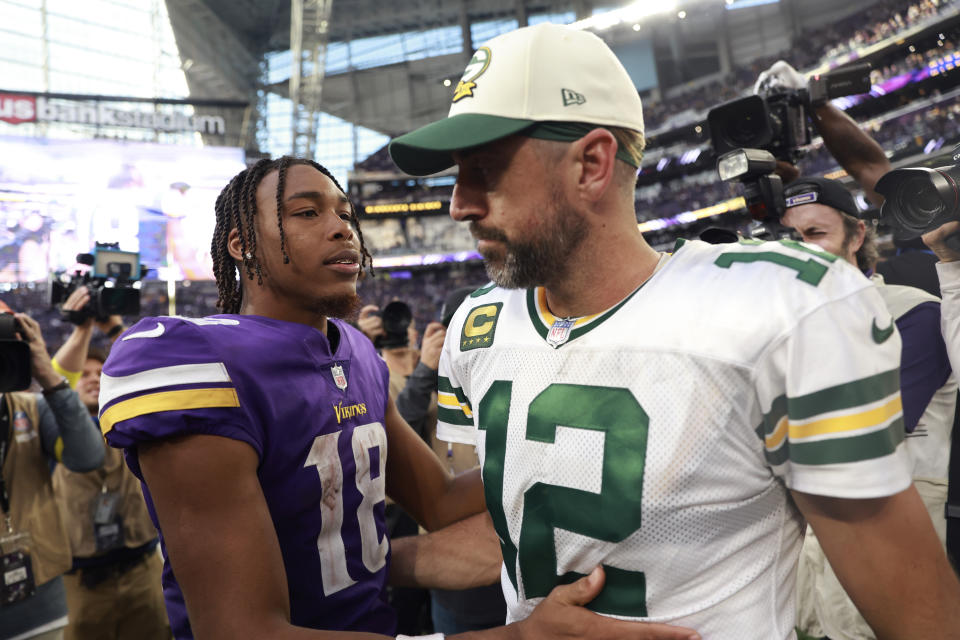 Minnesota Vikings wide receiver Justin Jefferson (18) talks with Green Bay Packers quarterback Aaron Rodgers (12) after an NFL football game, Sunday, Sept. 11, 2022, in Minneapolis. The Vikings won 23-7. (AP Photo/Abbie Parr)