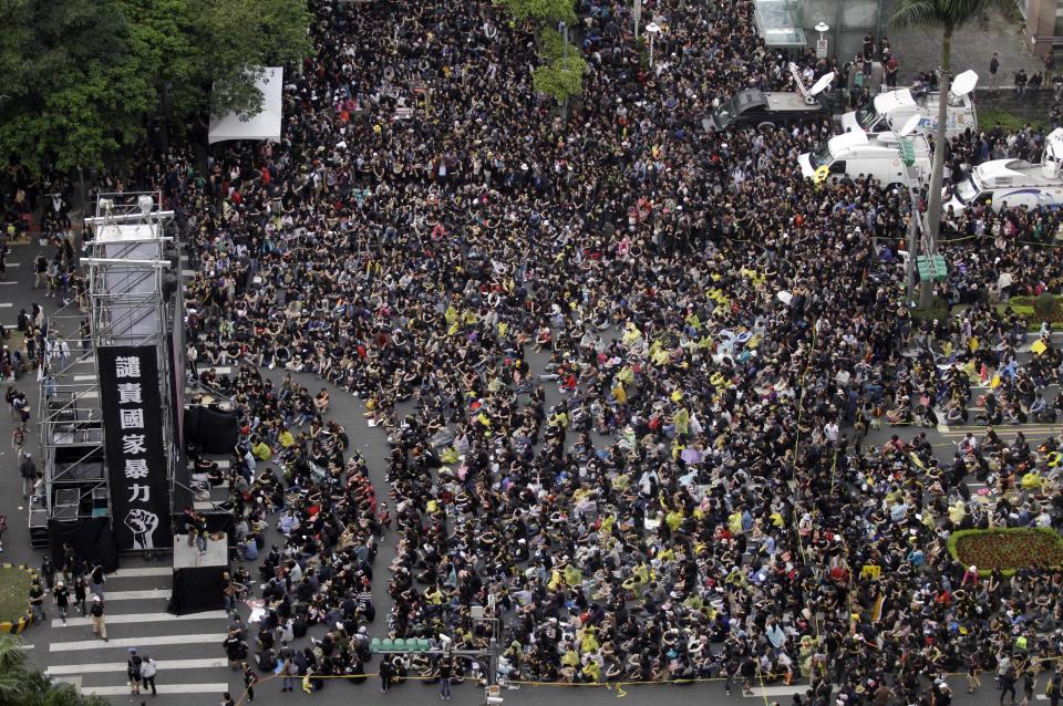 Thousands of protesters are seen in front of a stage with banner reading "condemn the violent government!" while supporting Taiwan during a massive protest over the controversial China Taiwan trade pact in front of the Presidential Building in Taipei, Taiwan, Sunday, March 30, 2014. Hundreds of thousands of demonstrators gathered in the streets around the parliament on Sunday to protest a trade pact with China, a nearly 2-week-old protest that is challenging the president’s policy of moving the democratic island economically closer to China. (AP Photo/Wally Santana)