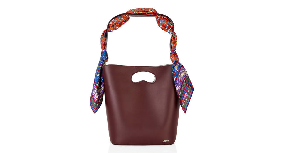 <p>Combining two classics (a Liberty scarf and a bucket bag), this beautiful leather bag is just what you need to take your wardrobe to the next level. It might come with a hefty price tag, but it will last you forever. <em><a rel="nofollow noopener" href="https://www.libertylondon.com/uk/sophia-leather-bucket-bag-with-imran-silk-scarf-R262773006.html?dwvar_000615494_color=74-BURGUNDY&listsrc=Bags#start=1" target="_blank" data-ylk="slk:Shop now.;elm:context_link;itc:0;sec:content-canvas" class="link ">Shop now.</a></em> </p>