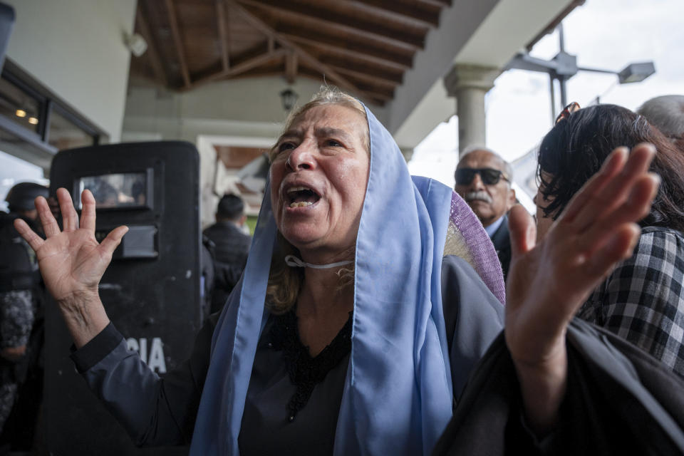 A supporter of slain presidential candidate Fernando Villavicencio mourns as his coffin arrives to Camposanto Monteolivo cemetery for burial in Quito, Ecuador, Friday, Aug. 11, 2023. The 59-year-old was fatally shot at a political rally on Aug. 9 in Quito. (AP Photo/Carlos Noriega)