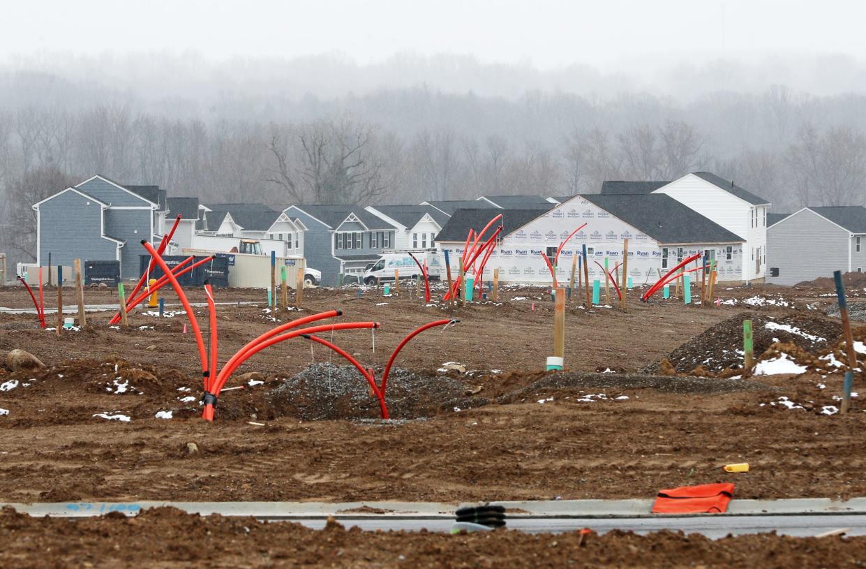 Housing lots are seen in the Brookside Greens housing development  in Norton on Monday. A wooded area adjacent to the development is being cleared for for a 130-foot water tower to come later this year.