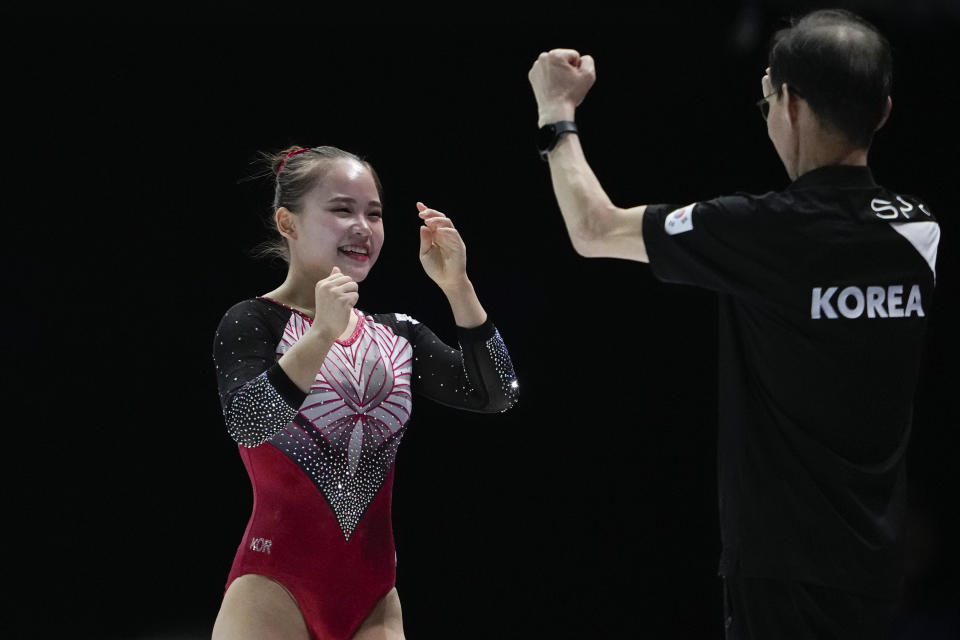 South Korea's Yeo Seojeong celebrates with her coach after her vault exercise during the apparatus finals at the Artistic Gymnastics World Championships in Antwerp, Belgium, Saturday, Oct. 7, 2023. (AP Photo/Virginia Mayo)