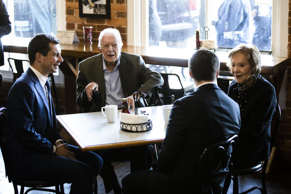 Democratic presidential candidate and former South Bend, Ind. Mayor Pete Buttigieg, left, and his husband Chasten Buttigieg, second from the right, meet with former President Jimmy Carter and former first lady Rosalynn Carter at the Buffalo Cafe in Plains, Ga., Sunday, March 1, 2020. (AP Photo/Matt Rourke)