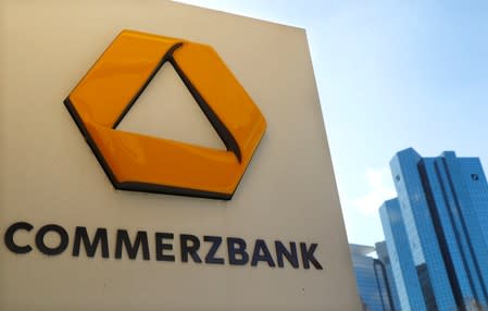 A sign for an ATM of Commerzbank is seen next to the headquarters of Deutsche Bank (R) in Frankfurt