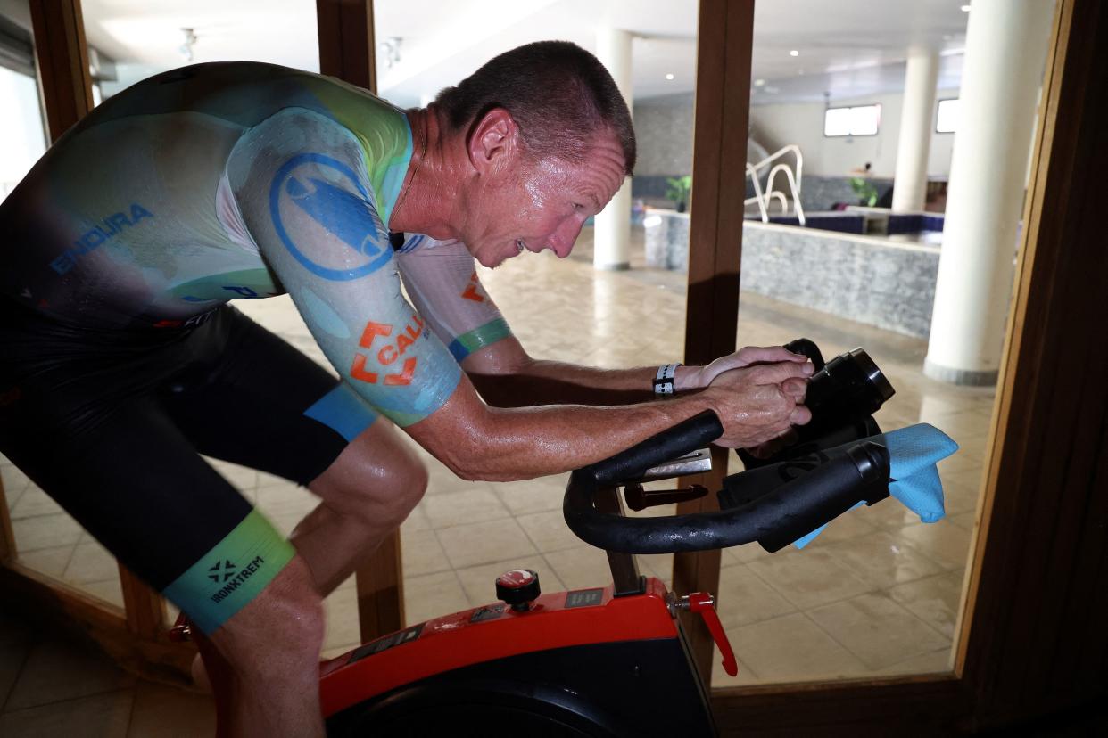 French triathlete Ludovic Chorgnon trains on an exercise bike in a sauna in La Possesion, on the French Indian Ocean island of La Reunion, on June 17, 2022. (Photo by Richard BOUHET / AFP) (Photo by RICHARD BOUHET/AFP via Getty Images)