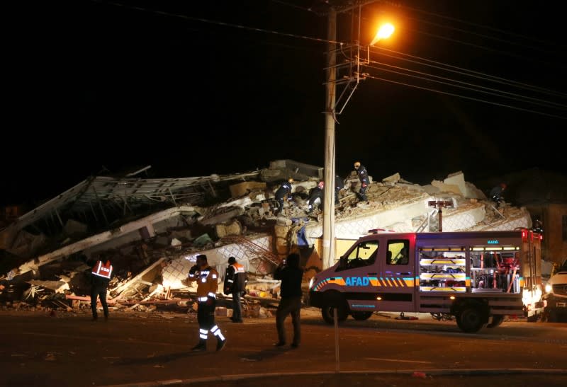 Rescuers work on a collapsed building after an earthquake in Elazig province