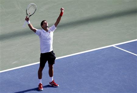 Novak Djokovic of Serbia celebrates after defeating Stanislas Wawrinka of Switzerland during their men's semi-final match at the U.S. Open tennis championships in New York September 7, 2013. REUTERS/Mike Segar