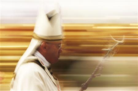 Pope Francis leaves at the end of the Chrism mass in Saint Peter's Basilica at the Vatican April 17, 2014. REUTERS/Stefano Rellandini