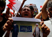 REFILE - ADDING RESTRICTION Supporters of Iraqi Shi'ite cleric Moqtada al-Sadr hold poster of Shi'ite cleric Ayatollah Sheikh Isa Qassim (R) during a demonstration in front of the Bahraini embassy in Baghdad, Iraq May 24, 2017. REUTERS/Wissm al-Okili